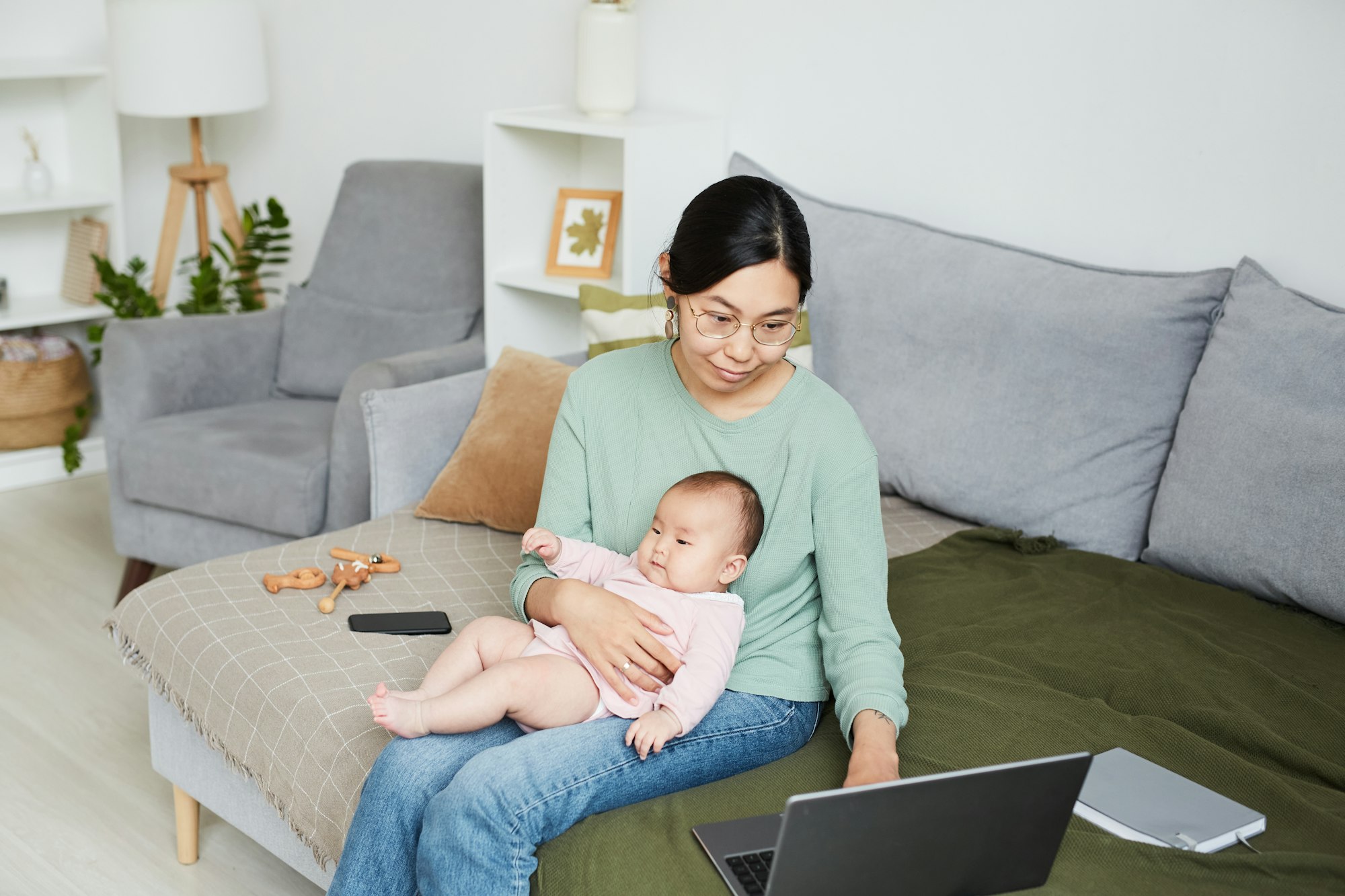 Woman working at home with baby