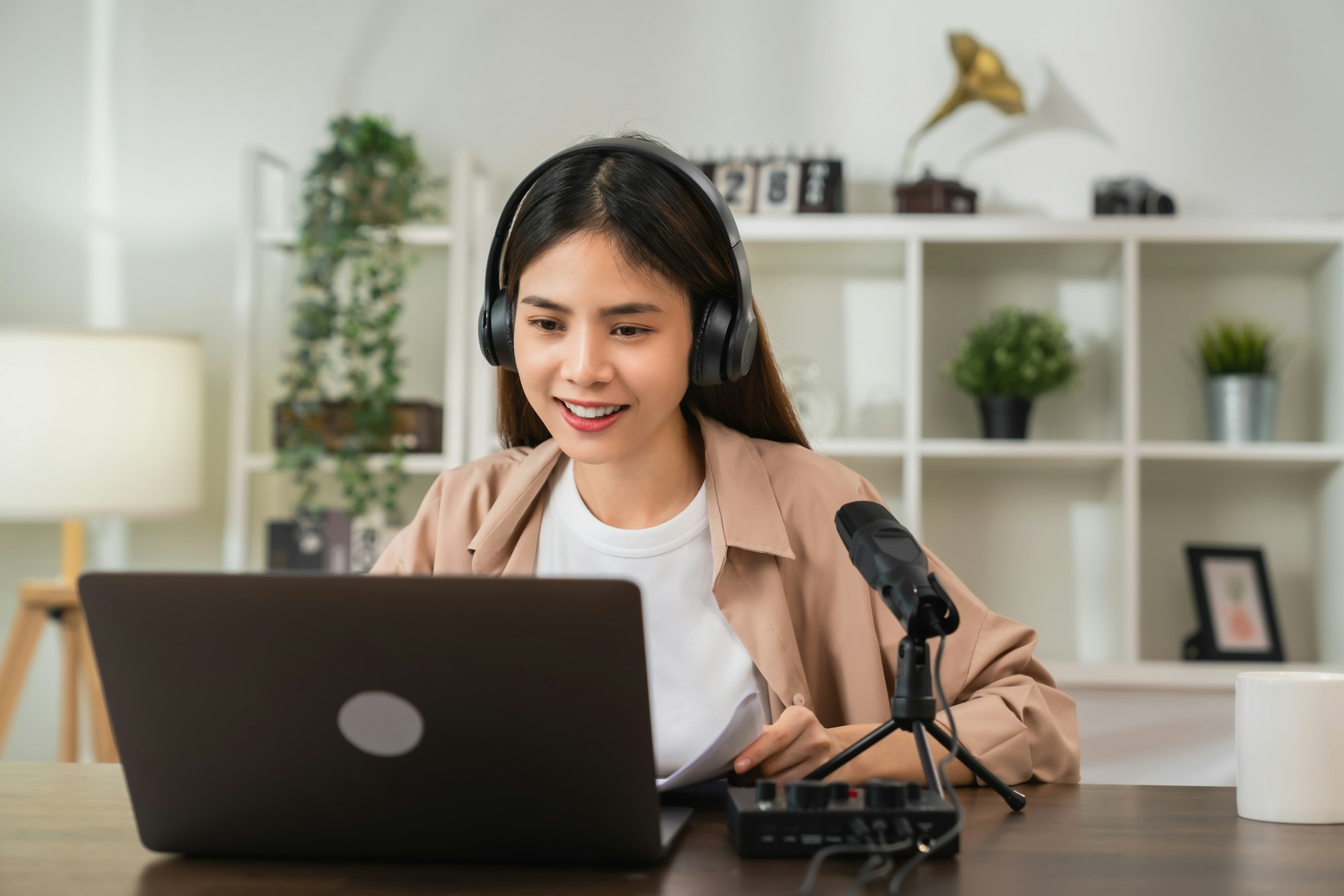 woman wearing headphones and using laptop at video calling meeting and study online on the Internet.