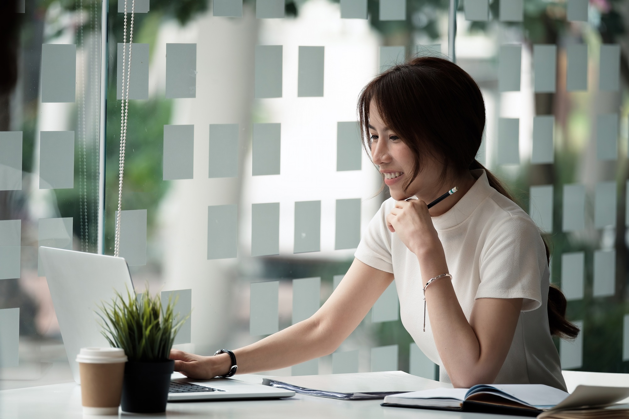 Happy asian woman using laptop computer for video conference. Online business education concept