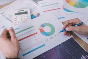 Cropped view of information security analyst planning strategy with charts at table