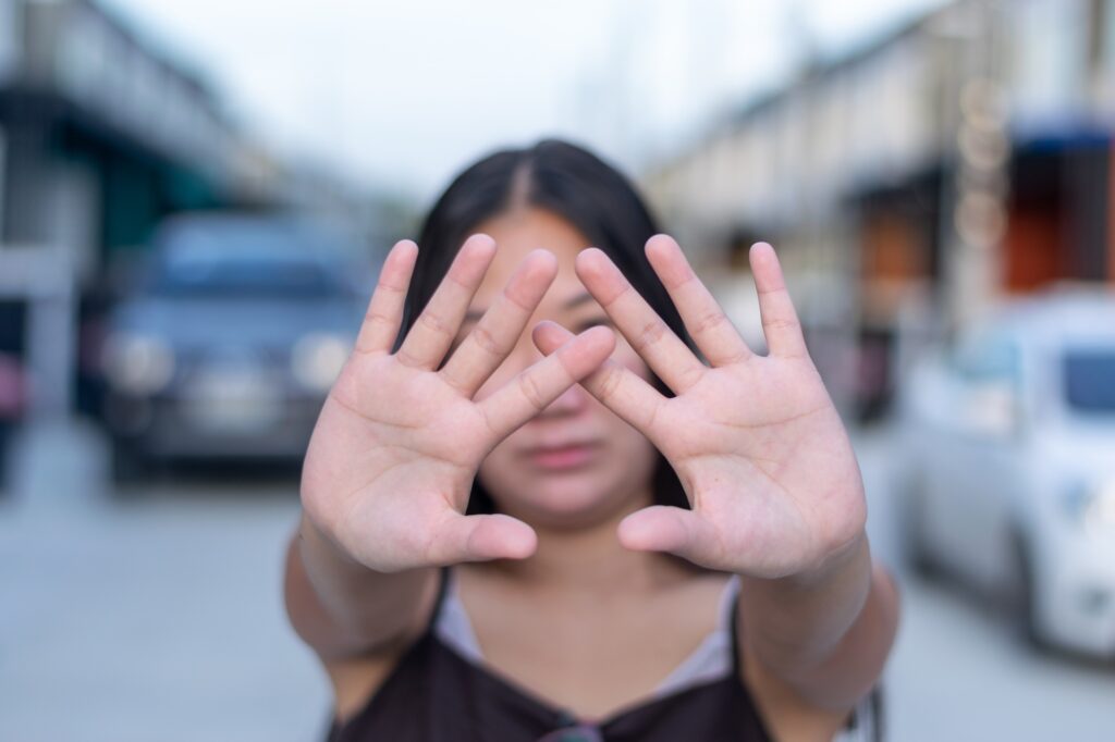 Young woman wearing casual clothes doing stop sing with palm of the hand.(hand focus).