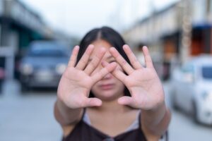 Young woman wearing casual clothes doing stop sing with palm of the hand.(hand focus).