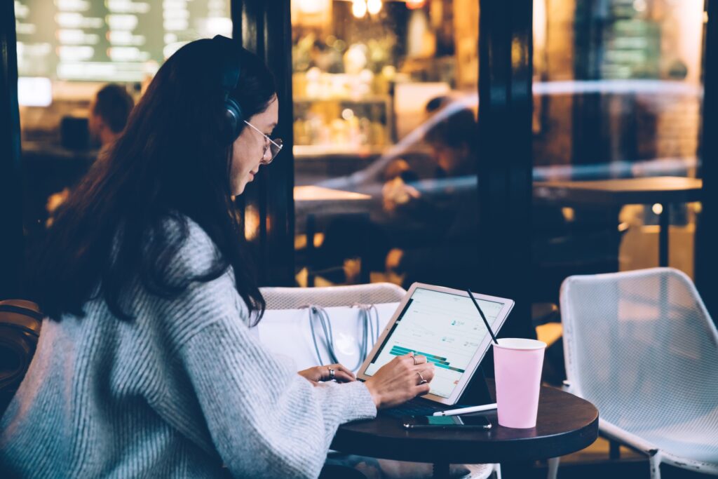 Woman using tablet in cafe
